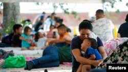 Solicitantes de asilo, en su mayoría de Venezuela, descansan a la sombra de una carpa cerca de la frontera mientras intentan cruzar a EEUU sin cita previa, en Nuevo Laredo, México, el 27 de junio de 2023. REUTERS/Daniel Becerril