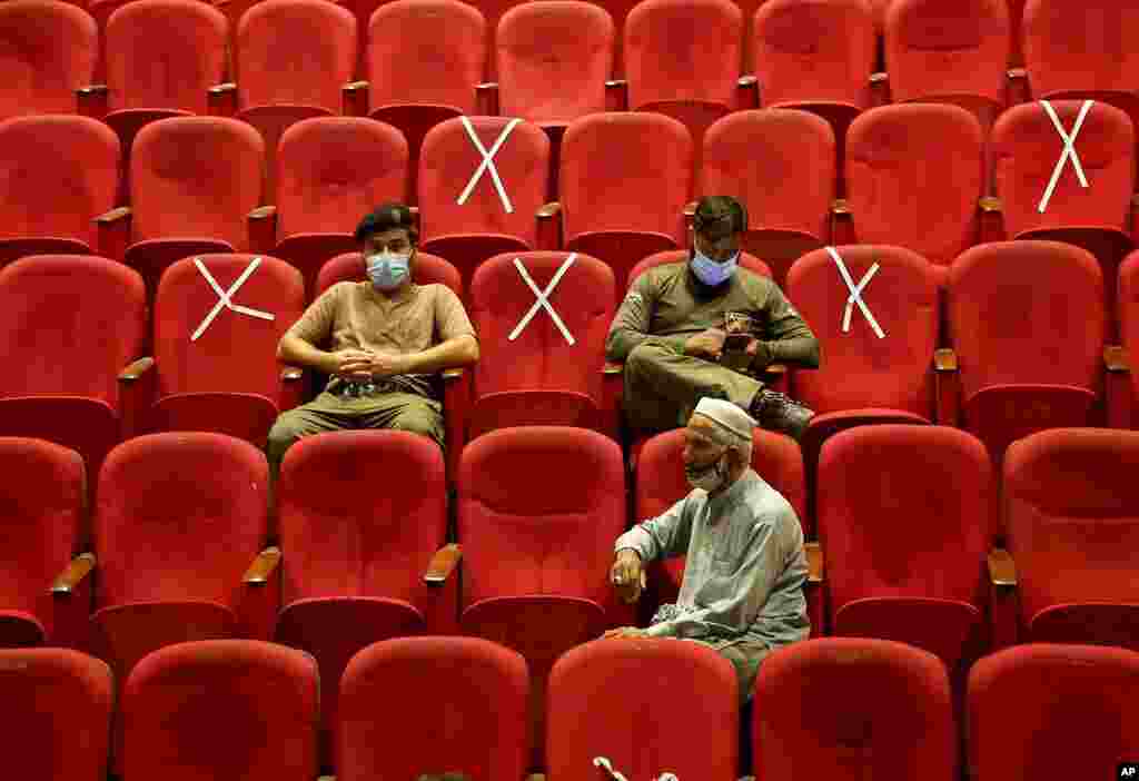 Government employees wait their turn to receive the Convidecia COVID-19 vaccine at a vaccination center in Nishtar hall, in Peshawar, Pakistan.