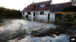 Water overflowing from the River Thames floods a house at Wraysbury, England, Feb. 10, 2014. 