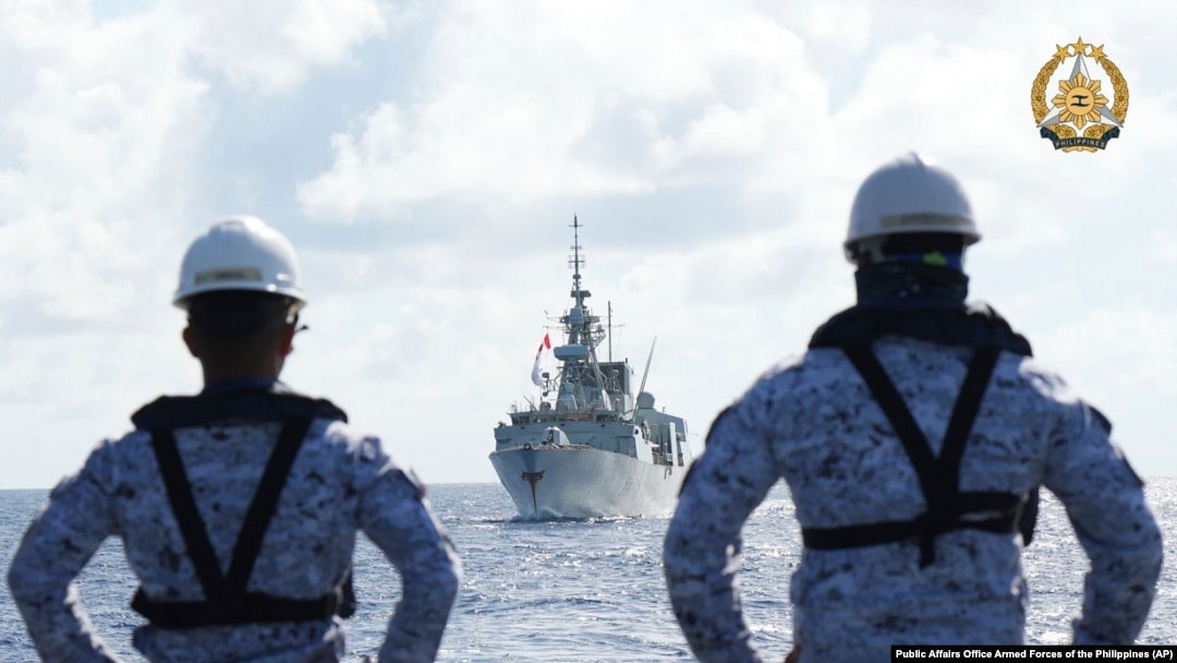 FILE - Philippine Navy personnel watch the Canadian vessel HMCS Montreal during the Multilateral Maritime Cooperative Activity being held in the West Philippine Sea, Aug. 7, 2024. 