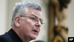 FILE - Archbishop John Nienstedt talks to reporters in St. Paul, Minn., after the Roman Catholic Archdiocese of St. Paul and Minneapolis filed for bankruptcy protection, saying it was the best way to get resources to tims of clergy sexual abuse.