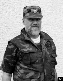 In this September 1991 photo, Slobodan Praljak poses near a front line in Sunja, Croatia. Praljak stunned the International Criminal Tribunal for the former Yugoslavia on Nov. 29, 2017, when he gulped down liquid from a small bottle seconds after a U.N. appeals judge had confirmed a 20-year sentence against him.