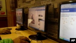 FILE - An Indian man surfs a Facebook page at an Internet cafe in New Delhi, India, Feb. 9, 2016.