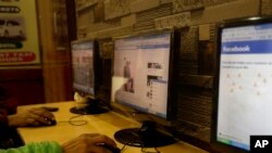 FILE - An Indian man surfs a Facebook page at an Internet cafe in New Delhi, India, Tuesday, Feb. 9, 2016.