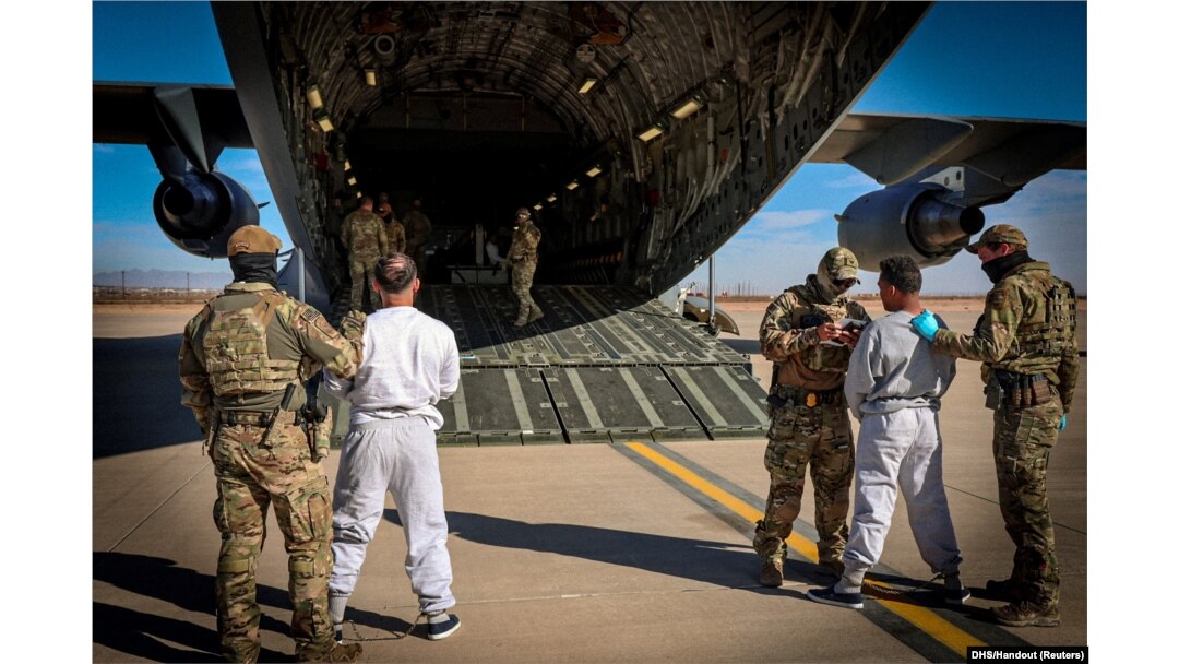 FILE - The first U.S. military aircraft to carry detained migrants to a detention facility at Guantanamo Bay is boarded from an unspecified location in the U.S., Feb. 4, 2025.