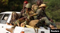 Seleka rebels ride in a truck as they leave their main base at Camp Deroux and head toward a smaller base in the PK12 neighborhood, in the north of the capital Bangui, Jan. 27, 2014.