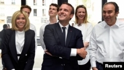 France's President Emmanuel Macron and his wife Brigitte speak with French entrepreneur and businessman Xavier Niel, right, during the inauguration of start-ups incubator "Station F," in Paris, France, June 29, 2017. 