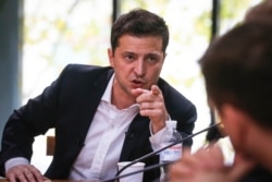 FILE - Ukrainian President Volodymyr Zelenskiy speaks during a session with journalists, in Kyiv, Ukraine, Oct. 10, 2019.