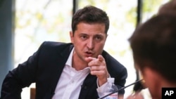 Ukrainian President Volodymyr Zelenskiy speaks during a session with journalists, in Kyiv, Ukraine, Oct. 10, 2019.