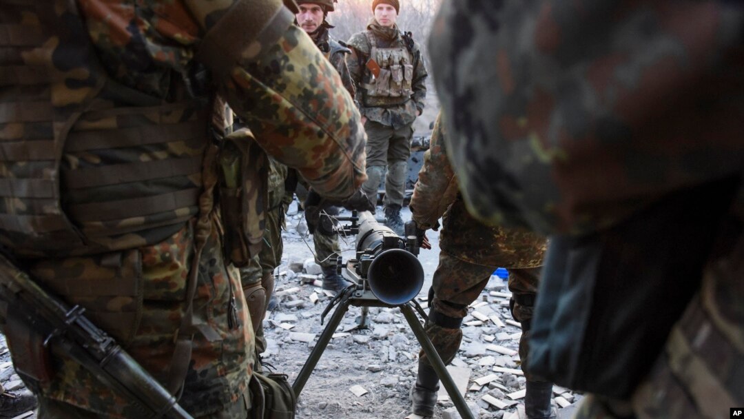 Fighters of the Azov Battalion prepare to fire an anti-tank weapon in the town of Shyrokyne, eastern Ukraine, March 23, 2015. 