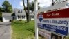 FILE - A "For Sale" sign stands in front of a house in Walpole, Massachusetts.