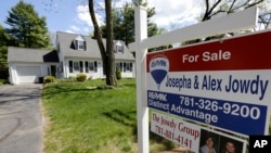 FILE - A "For Sale" sign stands in front of a house in Walpole, Massachusetts.