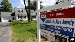 A "For Sale" sign stands in front of a house in Walpole, Mass. On Thursday, July 7, 2016, Freddie Mac reports on the week’s average U.S. mortgage rates.