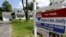 FILE - A "For Sale" sign stands in front of a house in Walpole, Massachusetts.