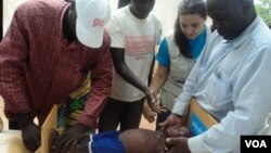 Medics near Garoua, Cameroon, evaluate Little Bossiran's height and weight to determine degree of malnourishment (VOA/D. Ntaryike)