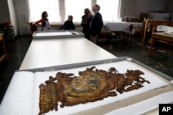 A fragment of a Barberini tapestry that was damaged in a 2001 fire is carefully preserved at the Textile Conservation Laboratory at the Cathedral of St. John the Divine in New York, March 22, 2017.