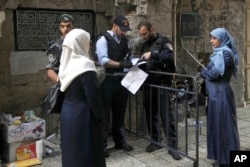 Israeli police check the papers of a Palestinian woman in Jerusalem's Old City, Oct. 8, 2015. Tensions have gripped the country for weeks.