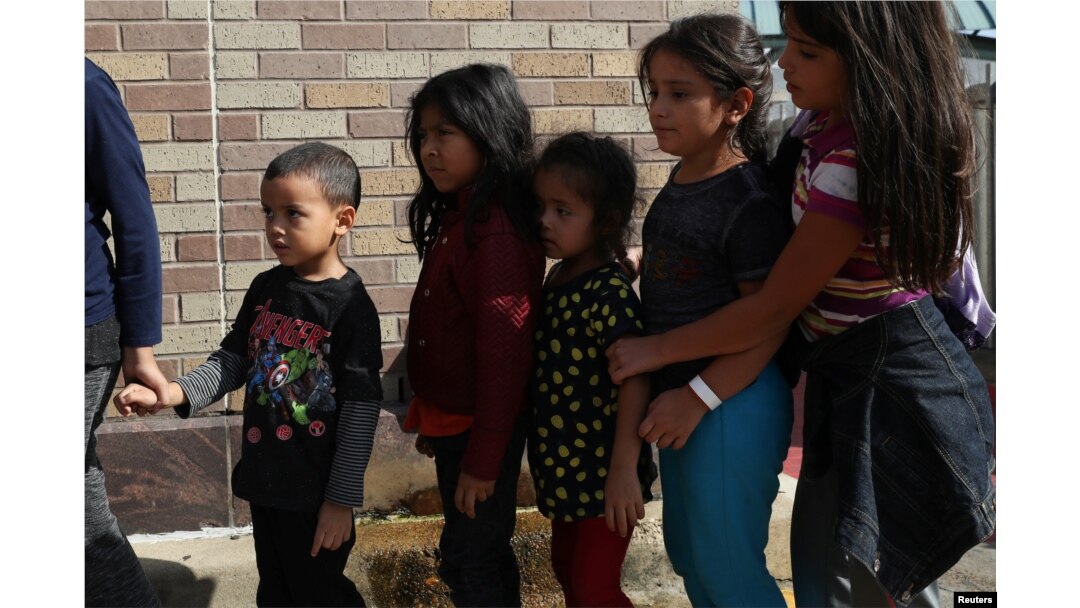 Children form a line as undocumented immigrant families are released from detention at a bus depot in McAllen, Texas, June 22, 2018.