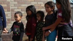 FILE - Children form a line as undocumented migrant families are released from detention at a bus depot in McAllen, Texas, June 22, 2018. 