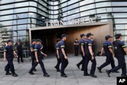 South Korean police patrol against possible rallies against Japan in front of a building where the Japanese embassy is located in Seoul, South Korea, July 19, 2019, after a man set himself on fire in front of the embassy.