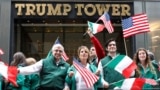 People wave flags as they pass Trump Tower during the 74th Annual Columbus Day Parade in Manhattan, New York, U.S., October 8, 2018. REUTERS/Shannon Stapleton