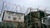 FILE - The front gate of Camp Delta is shown at the Guantanamo Bay Naval Station in Guantanamo Bay, Cuba.