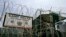 FILE - The front gate of Camp Delta is shown at the Guantanamo Bay Naval Station in Guantanamo Bay, Cuba.
