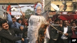 Activists from India's main opposition Bharatiya Janata Party (BJP) burn an effigy depicting India's Prime Minister Manmohan Singh during a protest against the government's decision to allow Foreign Direct Investment (FDI) in the retail sector, in New Del