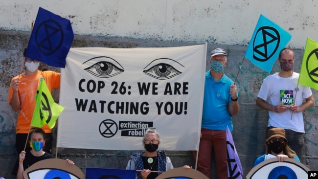 Extinction Rebellion activists protest on Muizenberg Beach in Cape Town, South Africa, Nov. 6, 2021.