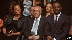 FILE - Former political prisoner Ahmed Kathrada, center, and wife of former president Nelson Mandela, Graca Machel, left, at the South African premier of the film "Mandela - Long Walk To Freedom," in Johannesburg, Nov. 3, 2013. Actor Idris Elba, who stars as Mandela, is at right.