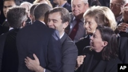 A member of the audience hugs President Barack Obama at the Interior Department in Washington after he signed the "Don't Ask, Don't Tell" repeal legislation that would allow gays to serve openly in the military, 22 Dec 2010