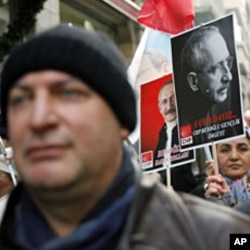 Supporters of the main opposition Republican People's Party (CHP) march with posters of their leader Kemal Kilicdaroglu during a protest against the government in central Istanbul, January 10, 2012