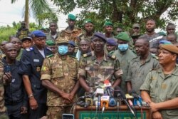Colonel-Major Ismael Wague, center, spokesman for the soldiers identifying themselves as National Committee for the Salvation of the People, speaks during a press conference at Camp Soudiata in Kati, Mali, Aug. 19, 2020.