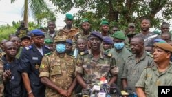 Colonel-Major Ismael Wague, center, spokesman for the soldiers identifying themselves as National Committee for the Salvation of the People, speaks during a press conference at Camp Soudiata in Kati, Mali, Aug. 19, 2020.