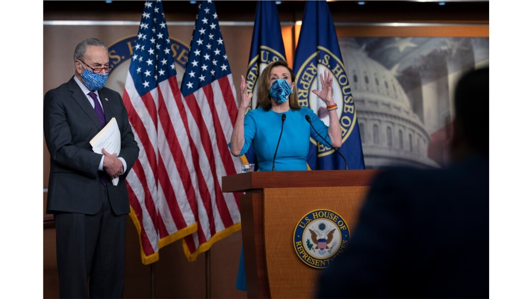FILE - House Speaker Nancy Pelosi and Senate Minority Leader Chuck Schumer, left, meet with reporters on Capitol Hill in Washington, Nov. 12, 2020.