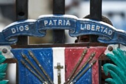 A youth peers though the closed gate at the border with Haiti in Jimani, Dominican Republic, July 8, 2021. Dominican President Luís Abinader closed the border on Wednesday, after Haitian President Jovenel Moise's assassination was reported.