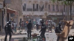 Demonstrators clash with riot policemen at a neighborhood in Dakar, Senegal, Thursday, June 1, 2023, after the country's opposition leader Ousmane Sonko was sentenced to two years in jail.