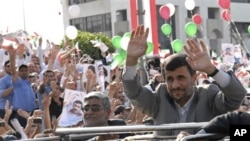 Iranian President Mahmoud Ahmadinejad waves to the crowds from the sunroof of his SUV upon his arrival in Beirut, Lebanon, 13 Oct 2010