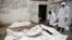 Workers pull bags containing bodies of victims of Saudi-led airstrikes on a Houthi detention center, at a hospital morgue in Dhamar, Yemen, Sept. 2, 2019. 