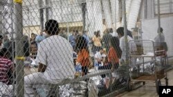 n this photo provided by U.S. Customs and Border Protection, people who've been taken into custody related to cases of illegal entry into the United States, sit in one of the cages at a facility in McAllen, Texas, June 17, 2018.
