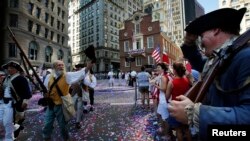 Re-enactors march away from the Old State House following a public reading of the United States Declaration of Independence, part of July Fourth Independence Day celebrations, in Boston, Massachusetts July 4, 2013.