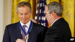 FILE - President George W. Bush presents the Presidential Medal of Freedom to former British prime minister Tony Blair, Jan. 13, 2009, during a ceremony at White House in Washington.