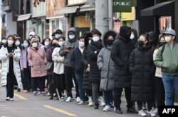 People wait in line to buy face masks at a store in the Dongseongro shopping district in Daegu, South Korea. South Korea has reported the most cases of the coronavirus cases outside of China.
