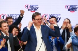 FILE - Serbian President Aleksandar Vucic gestures at Serbian Progressive Party (SNS) headquarters during a national election, the first in Europe since the outbreak of the coronavirus pandemic, in Belgrade, Serbia, June 21, 2020.