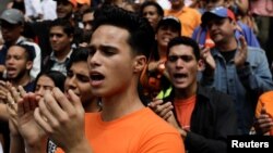 Opposition supporters shout during a gathering in front of the United Nations offices in Caracas, Venezuela, March 12, 2018. 