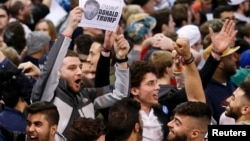 Demonstrators cheer after Republican U.S. presidential candidate Donald Trump cancelled his rally at the University of Illinois at Chicago, March 11, 2016. 