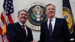 FILE - U.S. Trade Representative Robert Lighthizer, right, shakes hands with Britain's Secretary of State for International Trade Liam Fox as they arrive for a meeting at the Office of the U.S. Trade Representative in Washington, March 14, 2018.