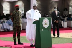 Nigerian President Muhammadu Buhari (C) delivers a speech at the launch of the largest rice pyramids in Abuja, Jan. 18, 2022.