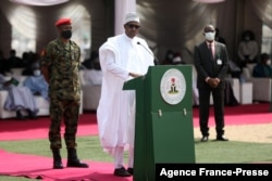 Nigerian President Muhammadu Buhari (C) delivers a speech at the launch of the largest rice pyramids in Abuja, Jan. 18, 2022.