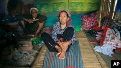 Ethnic Kachin Nlam Numrang Doi, 92, sits along with her husband Hkaraw Yaw, 102, at their hut in compound of Trinity Baptist Church refugee camp for internally displaced people in Myitkyina, Kachin State, northern Myanmar, May 6, 2018.